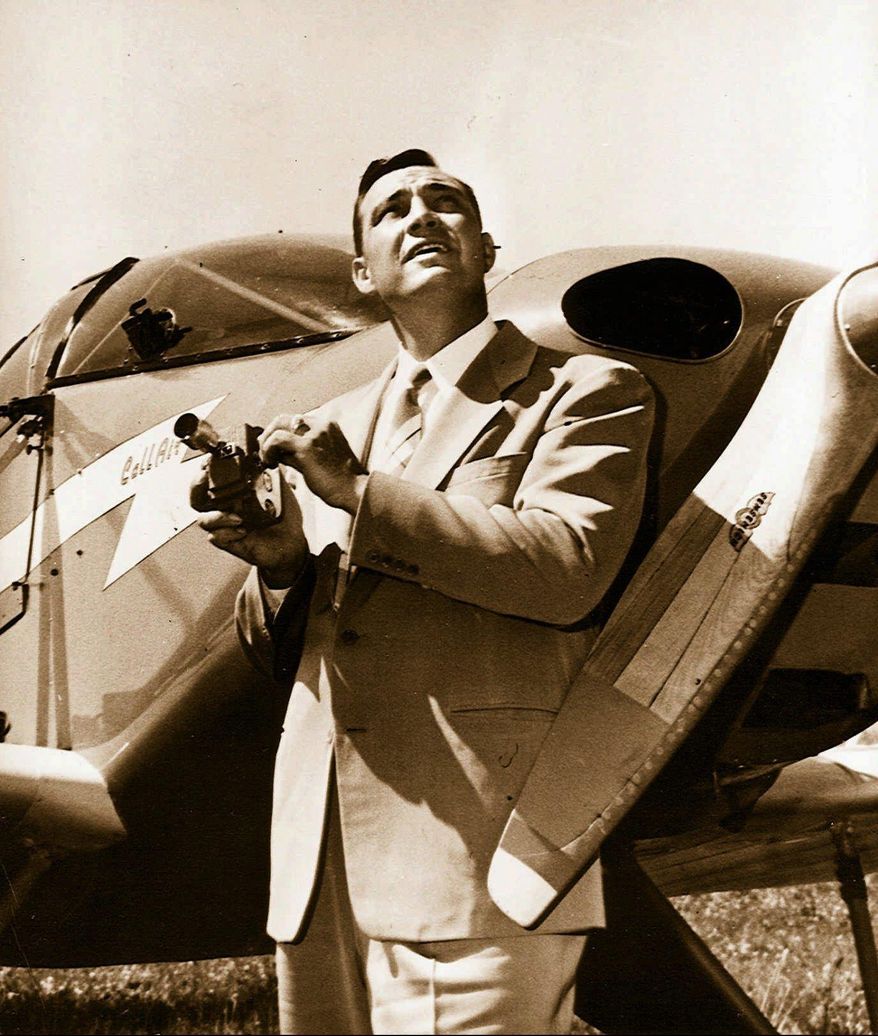 FILE - In this 1947, file photo, Kenneth Arnold, holds a movie camera in front of his CallAir, after he reported seeing nine alleged UFOs near Mount Rainier, Wash. Arnold had no idea he would change the world when he told reporters in Pendleton he saw nine strange objects flying along the Cascades. But 70 years ago June 25, that’s what he did. (Idaho Statesman via AP, File)