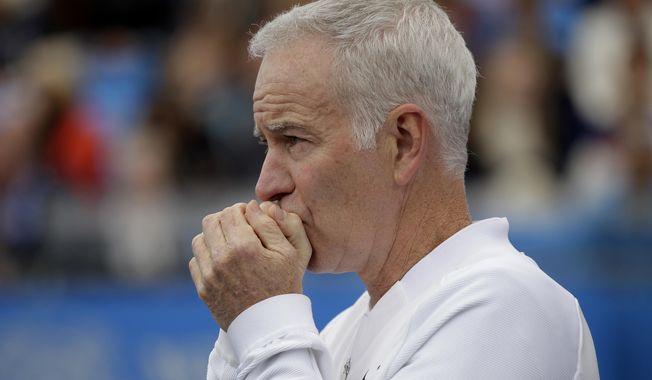 FILE - In a  Saturday June 18, 2016 file photo, John McEnroe, Coach to Canada&#x27;s Milos Raconic, looks across the court as Raconic plays Australia&#x27;s Bernard Tomic during their semifinal tennis match on the sixth day of the Queen&#x27;s Championships London. McEnroe wants to see players get fed up that they can&#x27;t break through against Roger Federer and Rafael Nadal, that they remain stuck behind Novak Djokovic and Andy Murray heading into Wimbledon.(AP Photo/Tim Ireland, File)