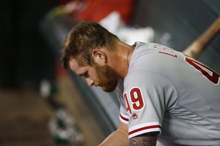 Philadelphia Phillies' Ben Lively sits in the dugout after being pulled from the baseball game during the sixth inning against the Arizona Diamondbacks on Saturday, June 24, 2017, in Phoenix. (AP Photo/Ross D. Franklin)