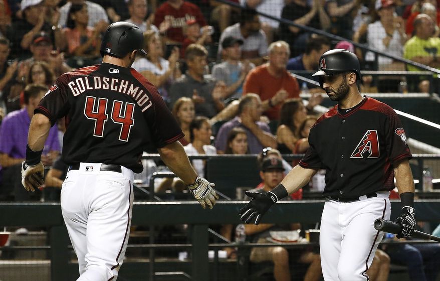 Arizona Diamondbacks' Paul Goldschmidt (44) celebrates with Daniel Descalso, right, after scoring against the Philadelphia Phillies during the fourth inning of a baseball game Saturday, June 24, 2017, in Phoenix. (AP Photo/Ross D. Franklin)