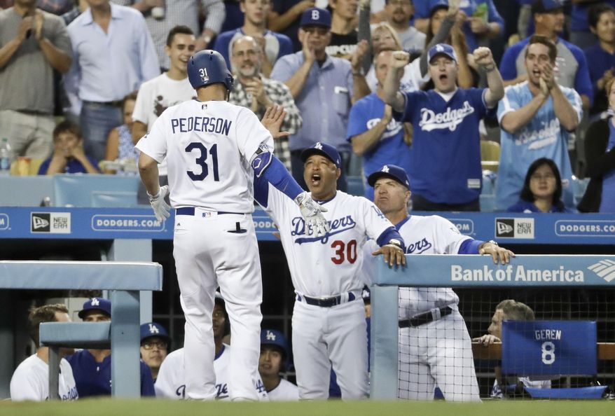 Los Angeles Dodgers' Joc Pederson celebrates in the dugout after hitting a home run against the Colorado Rockies during the third inning of a baseball game in Los Angeles, Saturday, June 24, 2017. (AP Photo/Chris Carlson)