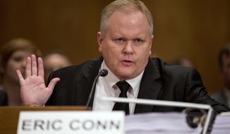 In this Oct 7, 2013, file photo, attorney Eric Conn gestures as he invokes his Fifth Amendment rights against self-incrimination during a Senate Homeland Security and Governmental Affairs committee hearing on Capitol Hill in Washington. Conn, a fugitive Kentucky lawyer at the center of a nearly $600 million Social Security fraud case, has fled the country using a fake passport and has gotten help from someone overseas with a job to help support himself, the Lexington Herald-Leader reported Sunday, June 25, 2017. (AP Photo/ Evan Vucci, File)