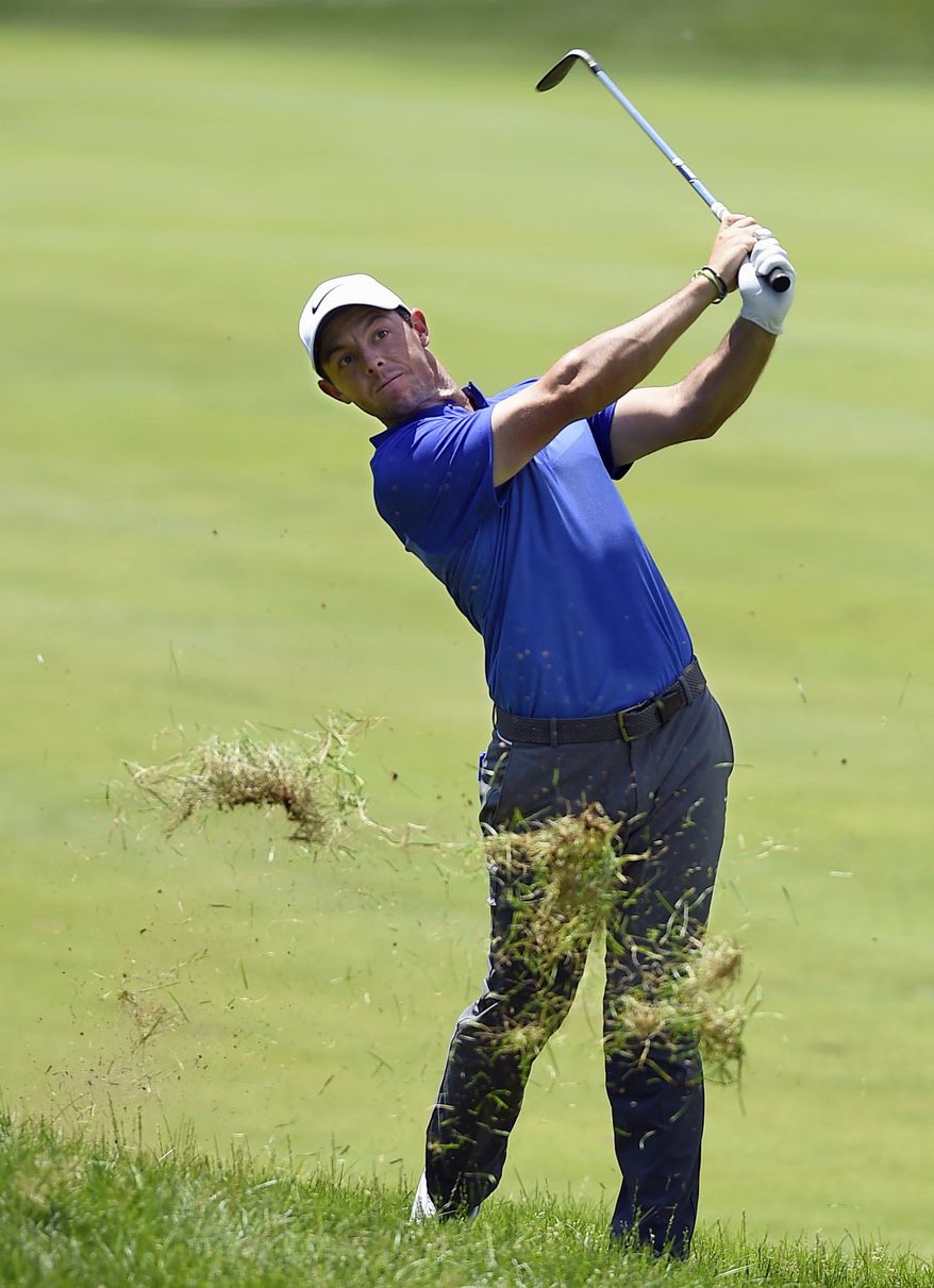 Rory McIlroy hits his second shot from the rough on the 18th hole during the final round of the Travelers Championship golf tournament, Sunday, June 25, 2017, in Cromwell, Conn. (AP Photo/Jessica Hill)