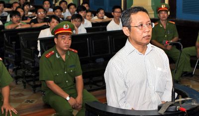 FILE - In this file photo dated Wednesday, Aug. 10, 2011, French-Vietnamese math professor Pham Minh Hoang appears in court in Ho Chi Minh City, Vietnam.  61-year old Pham Minh Hoang was arrested at his home in southern Ho Chi Minh City and forcibly exiled to France, he said during an interview Sunday June 25, 2017. (Hoang Hai/Vietnam News Agency FILE via AP)
