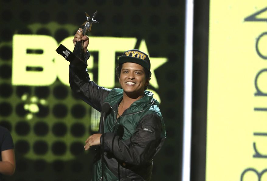 Bruno Mars accepts the award for best male R&B/pop artist at the BET Awards at the Microsoft Theater on Sunday, June 25, 2017, in Los Angeles. (Photo by Matt Sayles/Invision/AP)