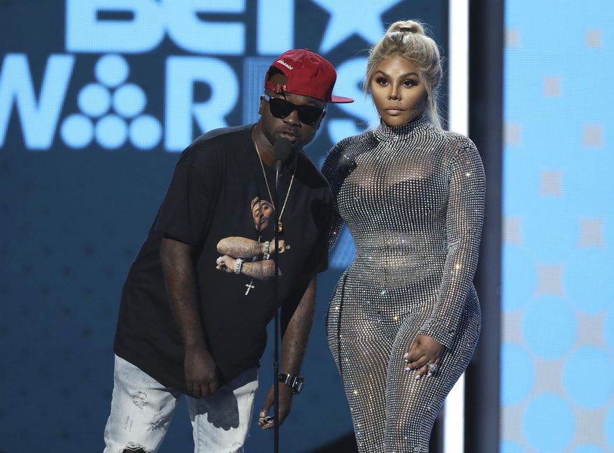 Havoc, left, and Lil Kim present the award for best male hip hop artist at the BET Awards at the Microsoft Theater on Sunday, June 25, 2017, in Los Angeles. (Photo by Matt Sayles/Invision/AP)