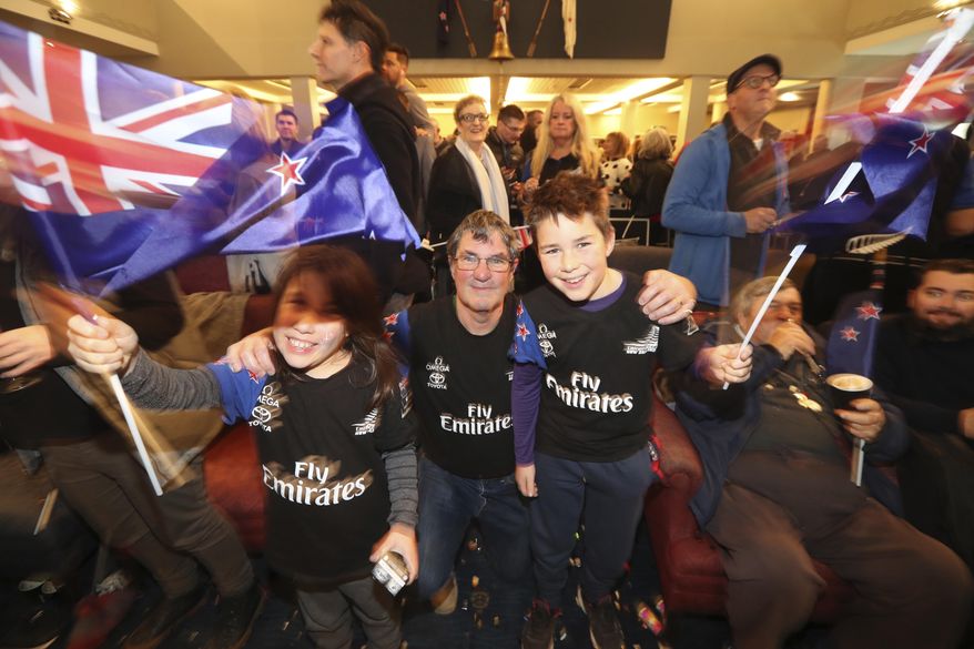 Fans of Emirates Team New Zealand celebrate in Auckland, New Zealand, Tuesday, June 27, 2017 after they defeated Oracle Team USA in the America's Cup in Hamilton, Bermuda. (Nick Reed/New Zealand Herald via AP)