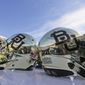 FILE - In this Dec. 5, 2015, file photo, Baylor helmets on shown the field after an NCAA college football game in Waco, Texas. The NCAA is conducting an “ongoing, pending investigation” into Baylor University in the wake of a sexual assault scandal that led to the firing of football coach Art Briles and the departure of the school president, the school’s lawyers confirmed in a federal court filing. (AP Photo/LM Otero, File)