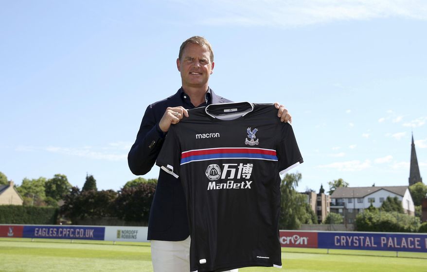 Frank De Boer holds up a team shirt during a photo call after a press conference at Beckenham Training Ground, Kent, Monday June 26, 2017. Former Netherlands defender Frank de Boer has been hired as manager of Crystal Palace, taking his first coaching job in English soccer seven months after getting fired by Inter Milan. (Steven Paston/PA via AP)