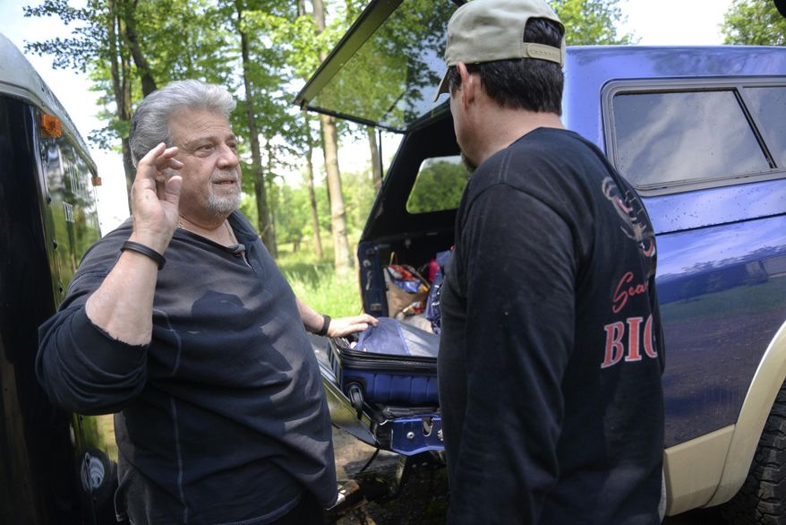 In a June 22, 2017 photo, Carmine 'Tom' Biscardi, left, talks with his son T.J. Biscardi, about their search for Bigfoot in Crawford County, Pa. (Shannon Roae/Meadville Tribune via AP)