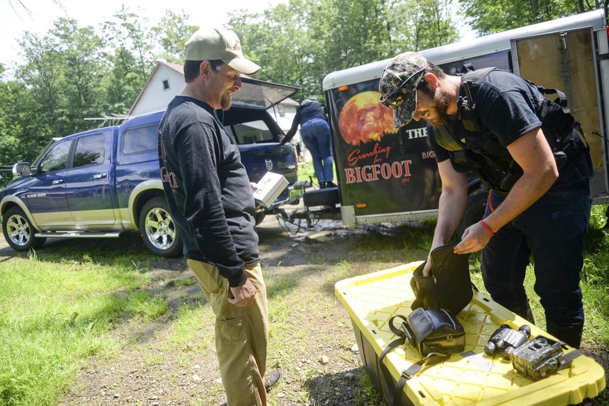 In a June 22, 2017 photo, T.J. Biscardi, left, and Francisco Correia pack up gear after a search for Bigfoot in Crawford County, Pa. (Shannon Roae/Meadville Tribune via AP)