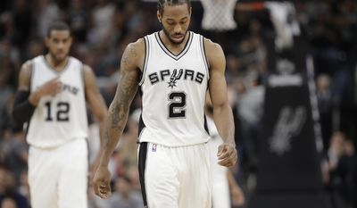 FILE - This May 9, 2017 file photo shows San Antonio Spurs forward Kawhi Leonard (2) walking on the court during the second half of Game 5 in a second-round NBA basketball playoff series against the Houston Rockets in San Antonio. The NBA will announce the winner of the MVP and the other individual honors during the first NBA Awards show in New York. Oklahoma City’s Russell Westbrook, Houston’s James Harden and San Antonio’s Kawhi Leonard are the finalists for MVP of the 2016-17 season. (AP Photo/Eric Gay)