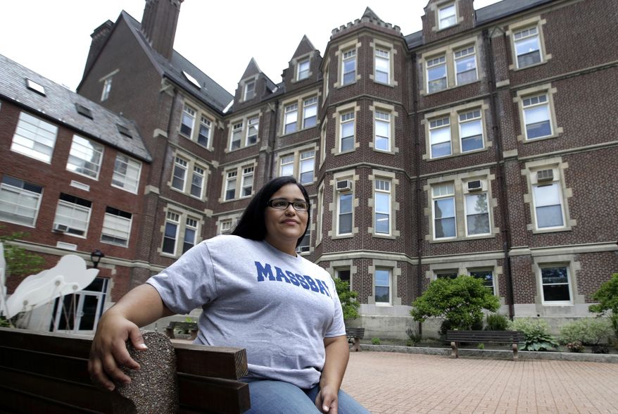 In this June 16, 2017, photo, Danielle Ramos, 30, poses at MassBay Community College in Wellesley, Mass., where she pursued her education after being defrauded by a for-profit college. Thousands of students who were defrauded by for-profit colleges were told by the Obama administration that their student loans would be forgiven, but the Trump administration has yet to keep that promise. (AP Photo/Elise Amendola)