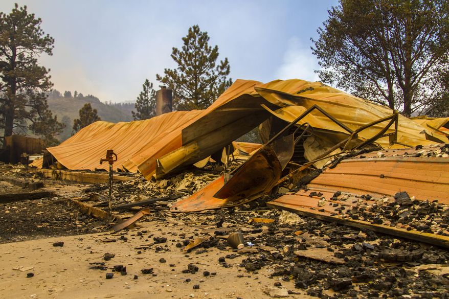 This Saturday, June 24, 2017, photo, shows a cabin burnt to the ground by a wildfire fire on the west side of Panguitch Lake, near Panguitch, Utah. Nearly 1,000 firefighters battled a Utah wildfire that grew Sunday morning that has prompted the evacuation of over a 1,000 people from hundreds of homes and cabins. (Jordan Allred/The Spectrum via AP)