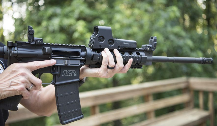 In this June 24, 2016, file photo, an AR-15 is held in Auburn, Ga. Gun rights advocates entered the Trump era with high hopes. After years of frustration, they thought a gun-friendly president and Congress would advance their agenda. (AP Photo/Lisa Marie Pane)