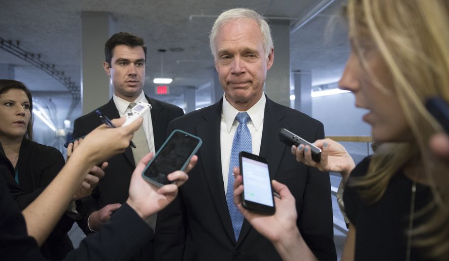 Sen. Ron Johnson, R-Wisc., center, who has expressed opposition to his own party&#x27;s health care bill, walks to a policy meeting as the Senate Republican legislation teeters on the brink of collapse, at the Capitol in Washington, Tuesday, June 27, 2017. Senate Majority Leader Mitch McConnell, R-Ky., needs 50 members of his conference to back the GOP health care bill in order to pass it. (AP Photo/J. Scott Applewhite)
