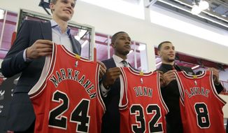 Chicago Bulls seventh overall draft pick Lauri Markkanen, left, Kris Dunn, center, and Zach Levine, pose for a photo at the NBA basketball team&#39;s training facility, Tuesday, June 27, 2017, in Chicago. Dunn and Levine was acquired by the Bulls from the Minnesota Timberwolves in exchange for Jimmy Butler and this year&#39;s No. 16th overall pick, Justin Patton. (AP Photo/G-Jun Yam)