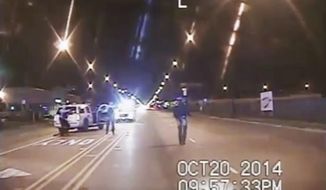 FILE - In this Oct. 20, 2014 file image taken from dash-cam video provided by the Chicago Police Department, Laquan McDonald, right, walks down the street moments before being fatally shot by Chicago Police officer Jason Van Dyke in Chicago. Three Chicago police officers have been indicted on felony charges alleging they conspired to cover up the fatal shooting of black teen Laquan McDonald by a white officer. The three officers, Thomas Gaffney, David March and Joseph Walsh, were each charged Tuesday, June 27, 2017, with conspiracy, official misconduct and obstruction of justice. (Chicago Police Department via AP, File)