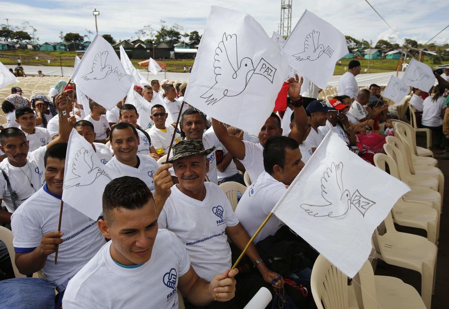 Rebels of the Revolutionary Armed Forces of Colombia, FARC, wave white peace flags during an act to commemorate the completion of their disarmament process in Buenavista, Colombia, Tuesday, June, 27, 2017. The United Nations says it has concluded the disarmament process for individual arms as part of a peace deal between Colombia&#39;s FARC rebels and the government. (AP Photo/Fernando Vergara)