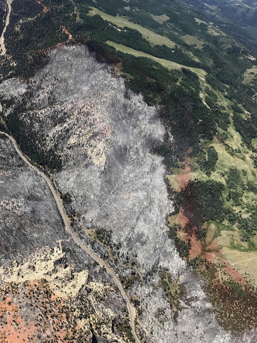 CORRECTS DATE TO JUNE 26 - This Monday, June 26, 2017, photo, provided by the Utah Governor's Office, shows slurry lines around burnout areas between Parowan and Brian Head, during a wildfire tour by Utah Lt. Gov. Spencer Cox, in southern Utah. The nation's largest wildfire has forced more than 1,500 people from their homes and cabins in a southern Utah mountain area home to a ski town and popular fishing lake. (Justin Harding/Utah Governor's Office via AP)