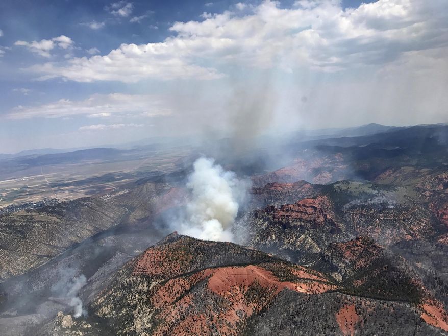 CORRECTS DATE TO JUNE 26 -This Monday, June 26, 2017, photo provided by the Utah Governor's Office, shows fire activity near Parowan, during a tour by Utah Lt. Gov. Spencer Cox, in southern Utah. The nation's largest wildfire has forced more than 1,500 people from their homes and cabins in a southern Utah mountain area home to a ski town and popular fishing lake. (Justin Harding/Utah Governor's Office via AP)