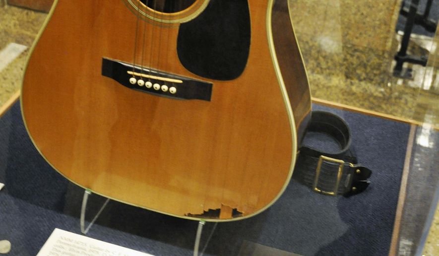 FILE - In this April 22, 2013, file photo, a slightly smashed acoustic guitar played by Elvis Presley during the final tour before his death in 1977 is displayed at the National Music Museum in Vermillion, S.D. Memorabilia collector Larry Moss, of Tennessee, is asking an appeals court to overturn a decision that awarded the guitar to the museum at the University of South Dakota. A federal judge ruled this year the museum could keep the guitar after Moss claimed he was the rightful owner. A three-judge panel from the 8th Circuit Court of Appeals will rule on the case. (AP Photo/Dirk Lammers, File)