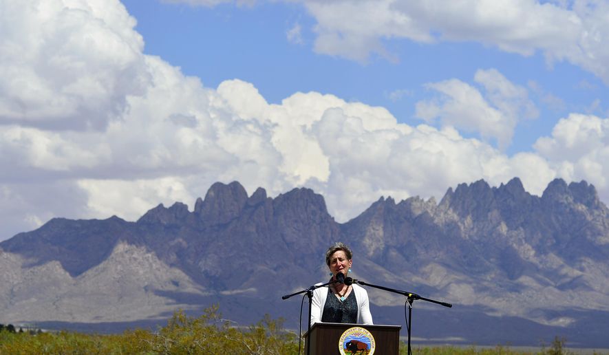 FILE - In this May 23, 2014 file photo, Secretary of the Interior Sally Jewell speaks with the local community and other federal, state, tribal and local leaders celebrating President Obama's designation of the Organ Mountains-Desert Peaks National Monument at Onate High School in Las Cruces, N.M. The Organ Mountains-Desert Peaks National Monument is among 27 monuments where a review has been ordered by President Donald Trump that might remove protections previously considered irreversible. (Carlos Javier Sanchez/The Las Cruces Sun-News via AP, file)