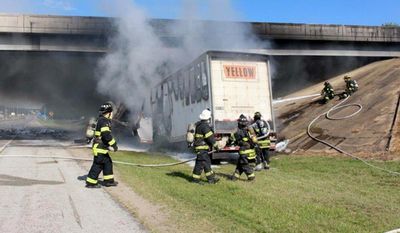 This photo provided by the Jonesboro Police Department shows emergency personnel at the scene Tuesday, June 27, 2017, where a tractor-trailer rig ran into a overpass on northbound Interstate 555 in Jonesboro, Ark. A police spokesman said the truck driver was killed in the accident. (Paul Holmes/Jonesboro Police Department via AP)
