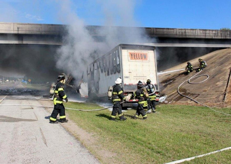 This photo provided by the Jonesboro Police Department shows emergency personnel at the scene Tuesday, June 27, 2017, where a tractor-trailer rig ran into a overpass on northbound Interstate 555 in Jonesboro, Ark. A police spokesman said the truck driver was killed in the accident. (Paul Holmes/Jonesboro Police Department via AP)