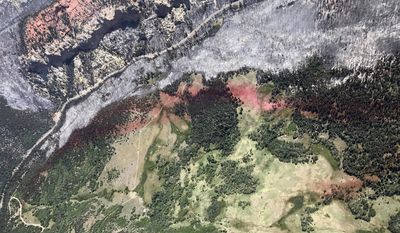This Monday, June 27, 2017, taken by Justin Harding, shows slurry lines around burnout areas near Parowan, during a tour by Utah Lt. Gov. Spencer Cox, in southern Utah. The nation's largest wildfire has forced more than 1,500 people from their homes and cabins in a southern Utah mountain area home to a ski town and popular fishing lake. (Justin Harding/ State of Utah, Office of the Governor, via AP)