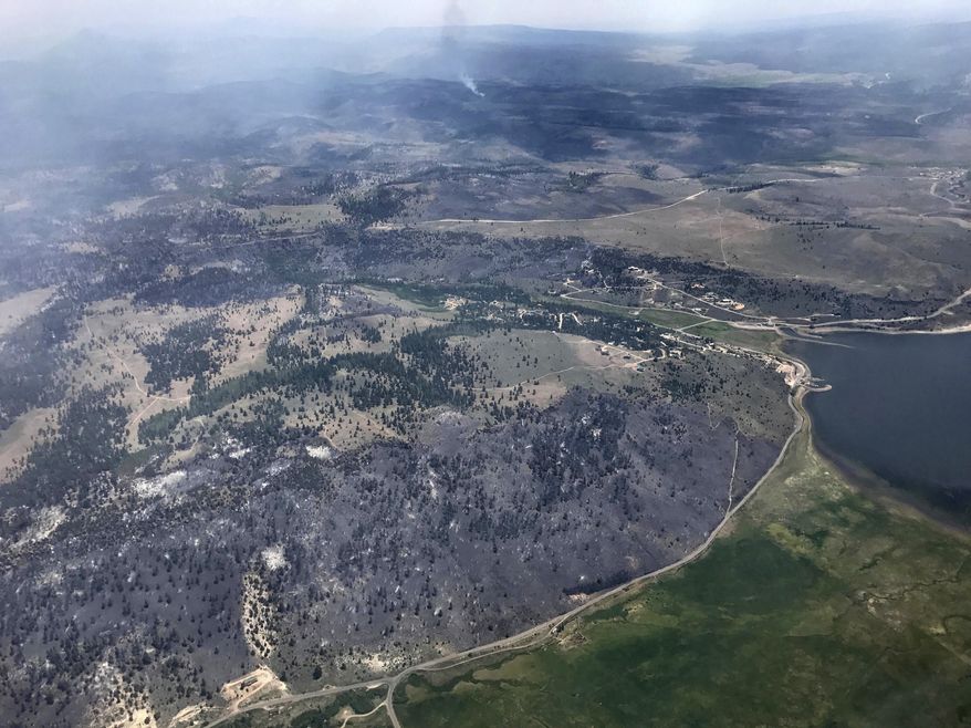This Monday, June 27, 2017, taken by Justin Harding, shows burnout areas near Panguitch Lake, during a wildfire tour by Utah Lt. Gov. Spencer Cox, in southern Utah. The nation's largest wildfire has forced more than 1,500 people from their homes and cabins in a southern Utah mountain area home to a ski town and popular fishing lake. (Justin Harding/ State of Utah, Office of the Governor, via AP)
