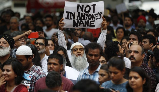 An Indian man holds a banner during a protest against a spate of violent attacks across the country targetting the country&#x27;s Muslim minority, in New Delhi, India, Wednesday, June 28, 2017. Carrying placards that said &quot;not in my name,&quot; the protestors on Wednesday decried the silence of India&#x27;s Hindu rightwing government in the face of the public lynchings and violent attacks on at least a dozen Muslim men and boys since it came to power in 2014. (AP Photo/Tsering Topgyal)