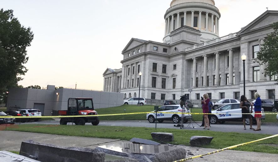 The new Ten Commandments monument outside the state Capitol in Little Rock, Ark., is blocked off Wednesday morning, June 28, 2017, after someone crashed into it with a vehicle, less than 24 hours after the privately funded monument was placed on the Capitol grounds. Authorities arrested a male suspect. (AP Photo/Jill Zeman Bleed)