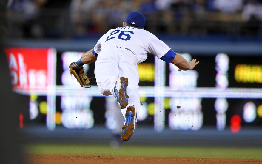 Los Angeles Dodgers second baseman Chase Utley can't reach the ball on a single by Los Angeles Angels' Yunel Escobar during the fourth inning of a baseball game, Tuesday, June 27, 2017, in Los Angeles. (AP Photo/Mark J. Terrill)