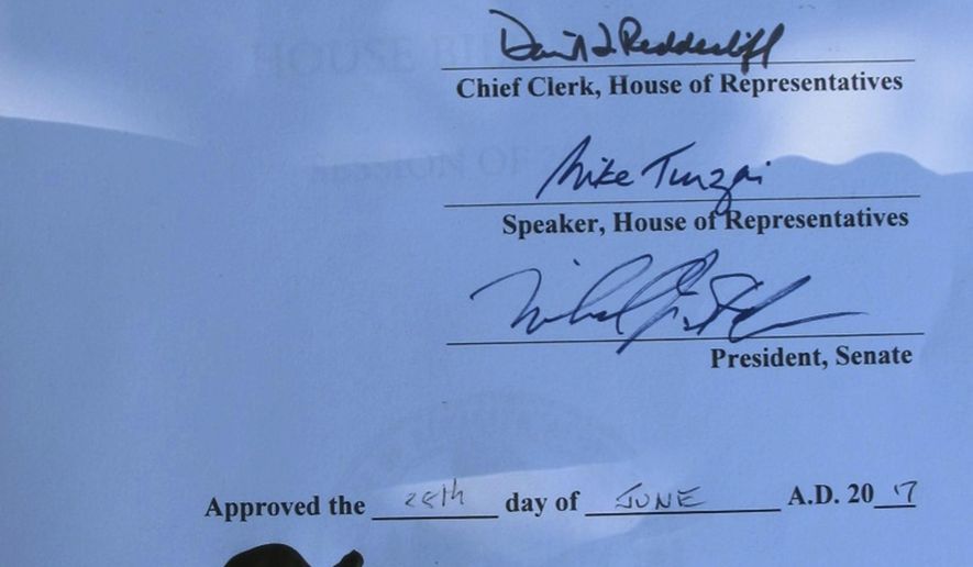 Pennsylvania's animal cruelty bill has the signature of Gov. Tom Wolf and even a paw print by Libre, a Boston terrier puppy who was emaciated and diseased when he was rescued last year by a delivery truck driver from an animal breeder in Lancaster County, Wednesday, June 28, 2017 in Harrisburg, Pa. (AP Photo/Marc Levy)