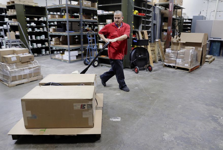 ADVANCE FOR MONDAY, JULY 3, 2017 - In this June 21, 2017 photo, Freddie Garcia gets a pallet of fire scanners ready to ship to Texas City in the warehouse of Industrial Equipment Company in Houston (Michael Wyke/Houston Chronicle via AP)