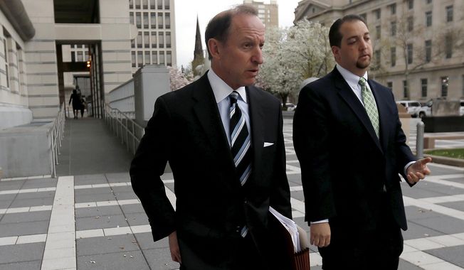 In this April 22, 2015, file photo, Abbe Lowell, (left) attorney for U.S. Sen. Bob Menendez, walks out of Martin Luther King Jr. Federal Court with Menendez&#x27; press secretary Steve Sandberg. Lowell, an attorney for Hunter Biden, blamed conservative media sources on Sunday for what he called &quot;false allegations&quot; of corruption against his client. (AP Photo/Julio Cortez, File)