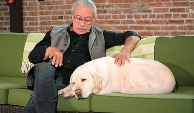This May 30, 2017 photo released by PETA shows actor Edward James Olmos with his dog Moe during the filming of a public service announcement in Los Angeles. Olmos teamed up with People for the Ethical Treatment of Animals to urge owners to comfort their pets or at least leave a TV or radio set on so they don’t get as scared during Fourth of July fireworks. (PETA via AP)