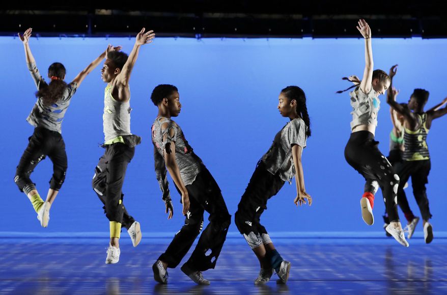 In this Thursday, June 8, 2017 photo, Jordan Miles and Asia You, tenth grade dance students at Ballet Tech, perform "The Jig Is Up," with schoolmates at the Joyce Theater in New York. (AP Photo/Mark Lennihan)