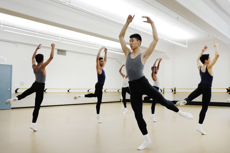 In this May 25, 2017 photo, Ballet Tech high school student Johnson Guo, center, participates in a ballet class in New York. Ballet Tech provides tuition-free dance training along with academics for students in grades 4 through 8, with about 50 fourth-graders admitted each year out of the thousands who audition. (AP Photo/Mark Lennihan)