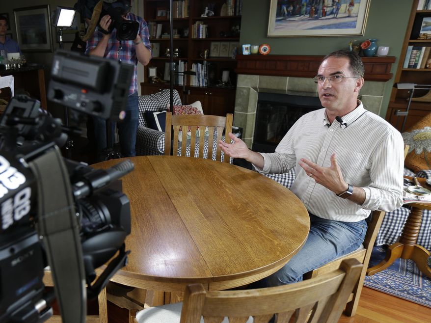 Mark Elster talks to reporters during a news conference in his home, Wednesday, June 28, 2017, in Seattle. Elster is a plaintiff in a new lawsuit challenging Seattle&#39;s first-in-the-nation voucher system for publicly financing political campaigns. (AP Photo/Ted S. Warren)