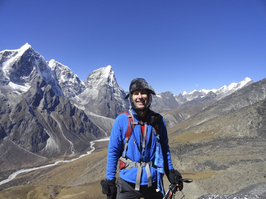 In this Oct. 12, 2012, photo, provided by Mike Scanlin, small business owner Scanlin poses for a photo on the trail to Mount Everest Base Camp in Nepal. Changes in technology have made it possible for vacationing small business owners to never be out of touch, unless they decide to go to a part of the world without enough cellphone towers, bandwidth or electricity. (Courtesy of Mike Scanlin via AP)