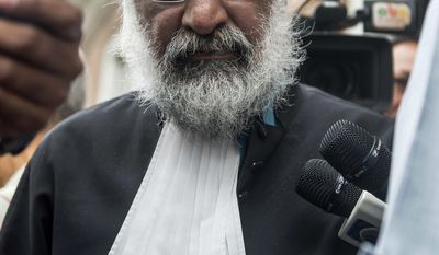 Irvin Kanhai, the attorney representing Suriname&#39;s President Desi Bouterse, talks to the press in Paramaribo, Suriname, Wednesday, June 28, 2017. Prosecutor Roy Elgin is calling for a 20-year prison sentence for the Suriname leader for his role in the December 1982 killing of 15 prominent political opponents in the South American country. (AP Photo/Pieter Van Maele)