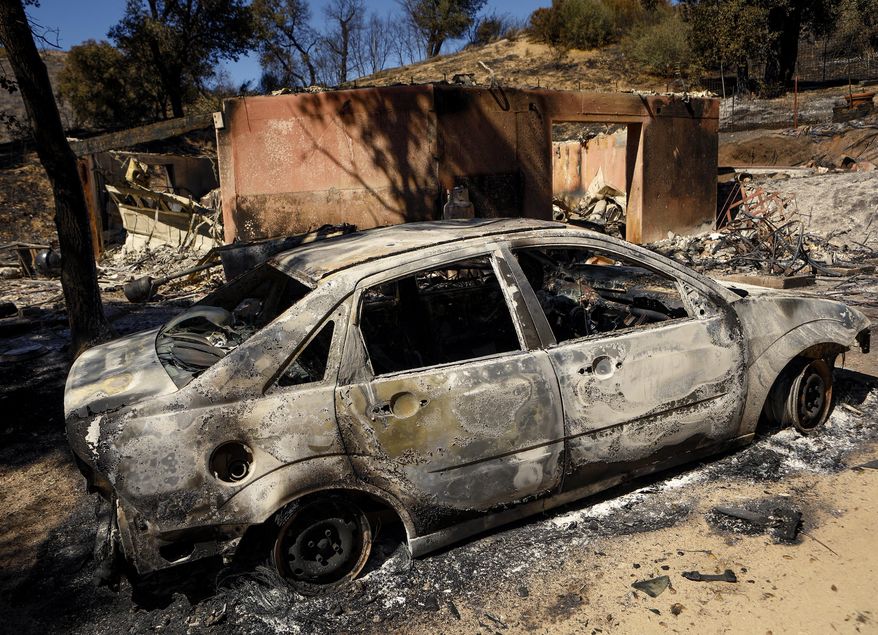 A burned out car sits next to a destroyed home after a wildfire in Santa Margarita, Calif., Wednesday, June 28, 2017. (Joe Johnston/The Tribune (of San Luis Obispo) via AP)