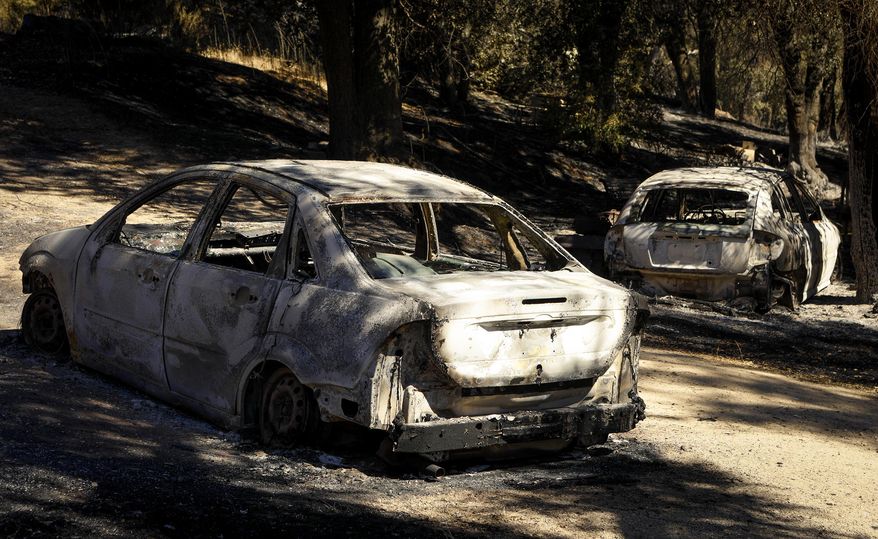 Burned out cars sit near a home that was destroyed by a wildfire in Santa Margarita, Calif., Wednesday, June 28, 2017. (Joe Johnston/The Tribune (of San Luis Obispo) via AP)
