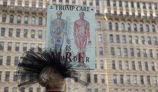 A person demonstrates against the GOP health care bill, Thursday, June 29, 2017, in Philadelphia. Senate Republican leaders considered keeping one of former President Barack Obama&#39;s big tax increases on wealthier Americans and using the money to fatten proposed subsidies for the poor in a bid Thursday to placate moderate GOP lawmakers and salvage their struggling health care bill. (AP Photo/Matt Slocum)