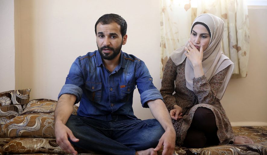 Mohammad al-Haj Ali, 28, and his wife Samah Hamidi, 25, pose for a photo during an interview in their home in Irbid, Jordan on Thursday, June 29, 2017. The family fled the Syrian war in 2012 for Jordan and was in the resettlement pipeline to the U.S. when President Donald Trump&#x27;s executive order stalled the process. Once sure of his future in the U.S., al-Haj Ali had quit his job, sold the furniture and rented an apartment in the city of Rockford near his uncle&#x27;s home in Illinois. The family still has five suitcases packed but has scant hope for resettlement in America. (AP Photo/Reem Saad)