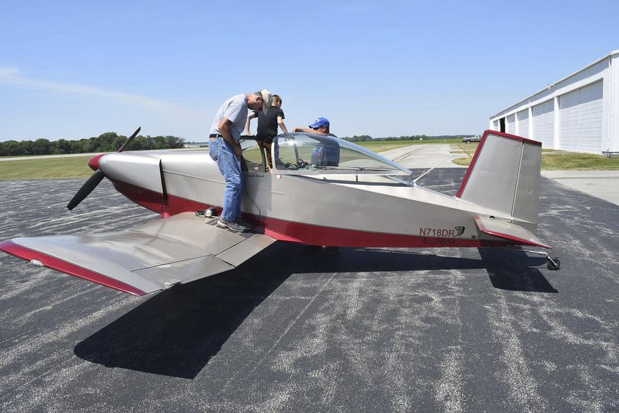 In this June 10, 2017 photo, David Read stands on the wing of his home-built Thorp T-18 as his passenger gets help out of the aircraft at Effingham County Memorial Airport in Effingham, Ill. Read provided free flights as part of the the Experimental Aircraft Association Chapter 16 Young Eagles flight experience. Volunteer pilots, many in their own planes, provided the basic flight lessons and experience to anyone ages 8 to 17. (Dawn Schabbing/Effingham Daily News via AP)