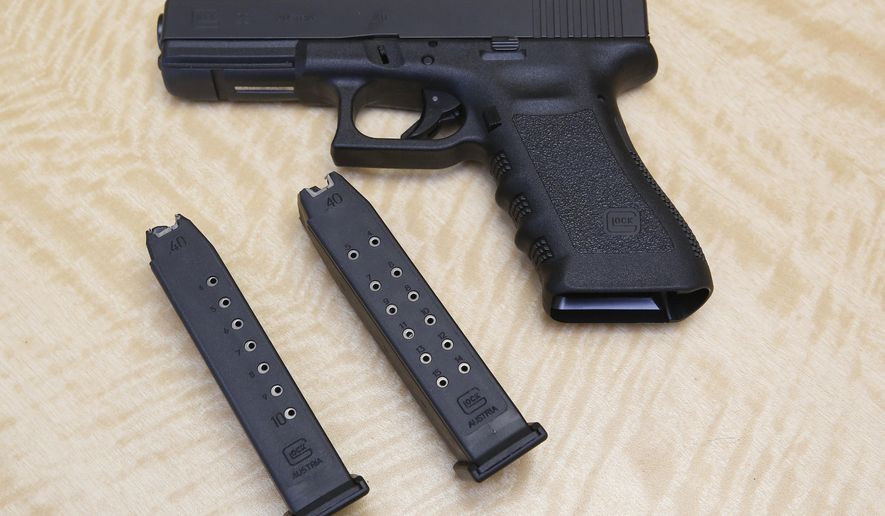 In this Tuesday, June 27, 2017 file photo, a semi-automatic hand gun is displayed with a 10 shot magazine, left, and a 15 shot magazine, right, at a gun store in Elk Grove, Calif.  (AP Photo/Rich Pedroncelli) **FILE**