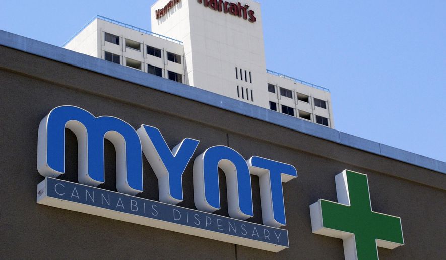 FILE- In this June 21, 2017, file photo, a sign on the Mynt Cannabis Dispensary across the street from Harrah's hotel-casino in downtown Reno, Nev., is shown. Recreational marijuana becomes legal to buy Saturday, July 1, in Nevada and officers say they have been preparing for months to enforce the law passed by voters in November. They will focus on keeping stoned drivers off the road but also will crack down on those illegally using pot in public, which carries a $600 fine for a first offense. (AP Photo/Scott Sonner, File)